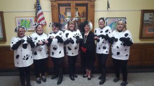 Principal Tracy Kent dressed up like Cruella de Vil and her dalmatian puppies