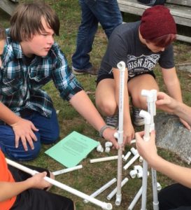 Students work with PVC pipes outdoors