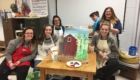 Art students and a red barn painting