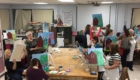 School and community members gathered in the art room at Berlin High School for a Paint N' Pizza Night