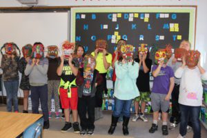 4th grade students show masks they made